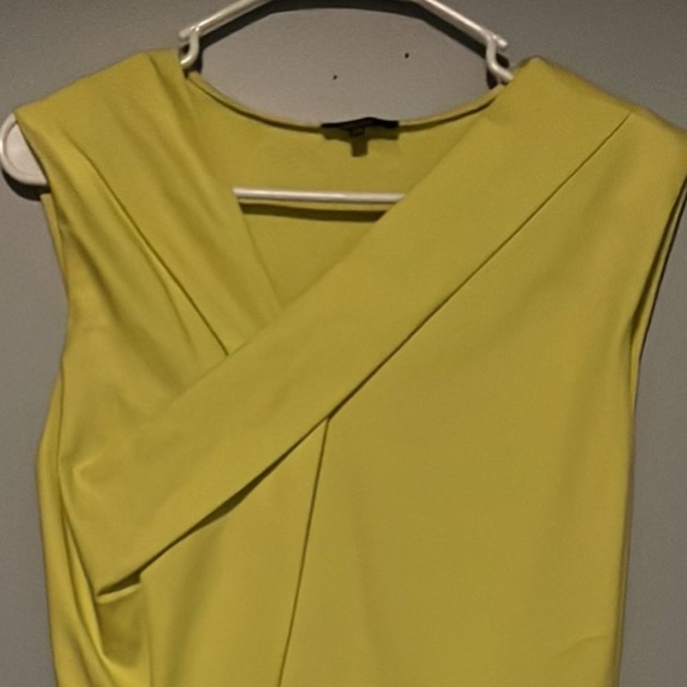 Yellow asymmetrical top and flair bottom dress with pockets. Size 8.